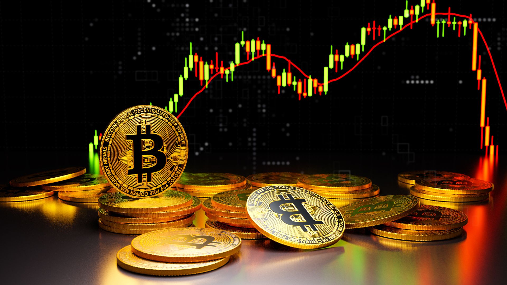 Stacked gold Bitcoin coins in front of a candlestick price chart showing a rise followed by a sharp drop, on a dark background